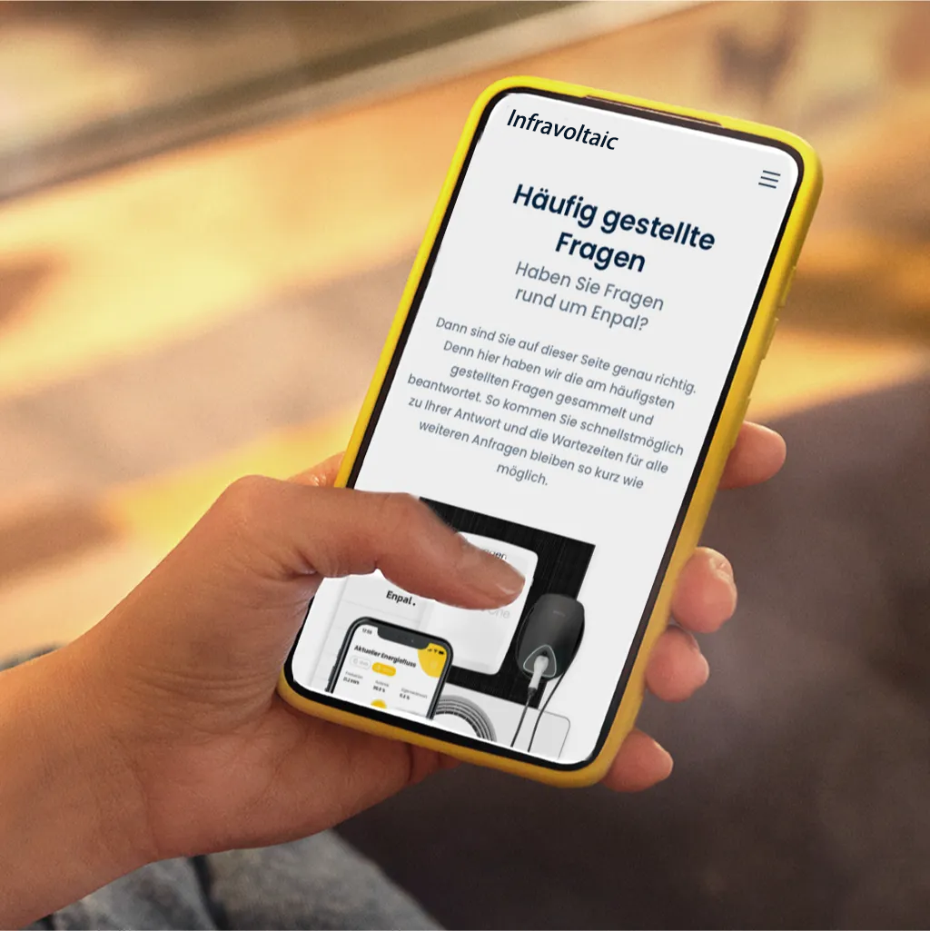 Hand mit Handy und der Infravoltaic FAQ-Seite